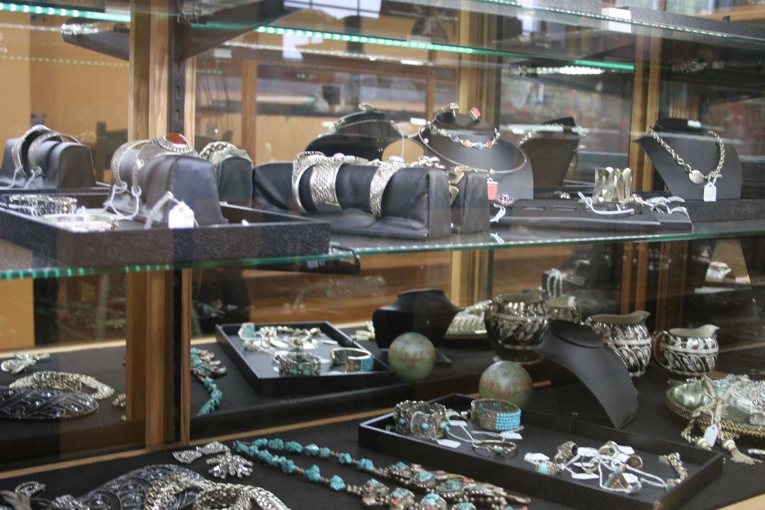 Different kinds of jewelry displayed inside a glass