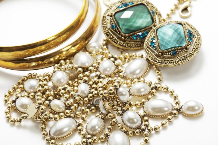 Collection of vintage jewelry on white surface